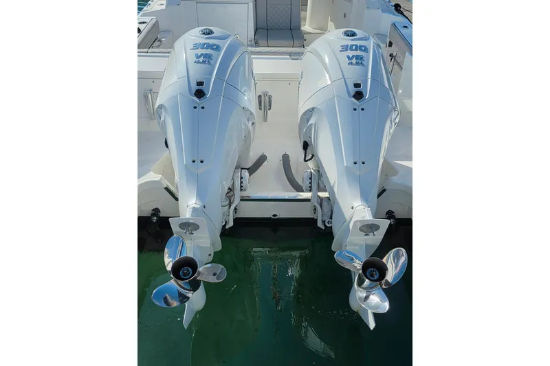 Slide: The Image of 2024 Pursuit OS 325 Offshore boat with twin Yamaha engines on calm water. - 5
