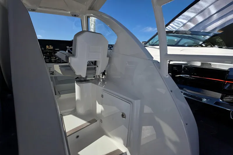 Slide: The Image of 2024 Pursuit OS 325 Offshore boat interior with helm seat and control panel. - 50