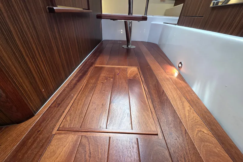 Slide: The Image of 2024 Pursuit OS 325 Offshore interior with elegant wooden flooring and ambient lighting. - 52