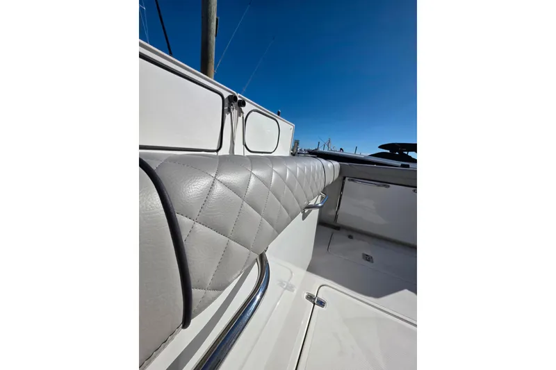 Slide: The Image of 2024 Pursuit OS 325 Offshore boat cruising on calm water under clear blue sky. - 7