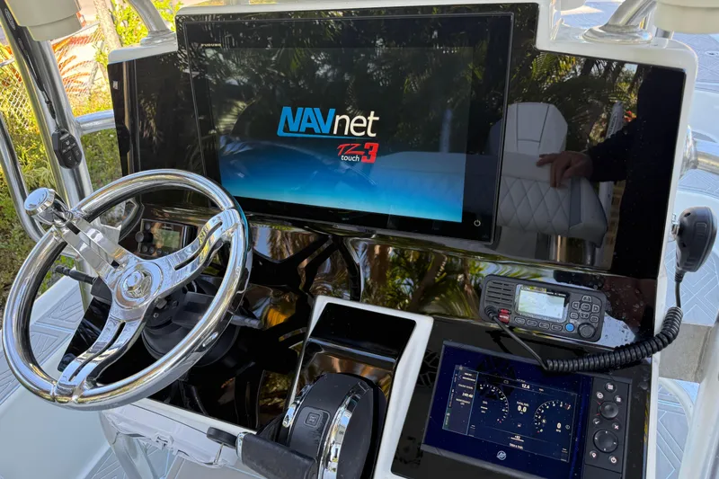 Slide: The Image of 2016 Yellowfin 24 Bay boat dashboard with NAVnet TZtouch3 display and steering wheel. - 16