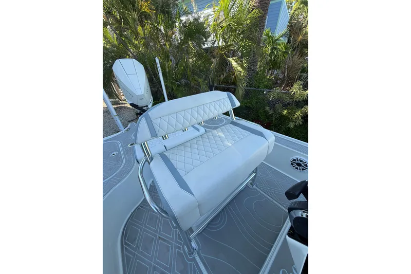 Slide: The Image of 2016 Yellowfin 24 Bay boat with cushioned seating and sleek design. - 17