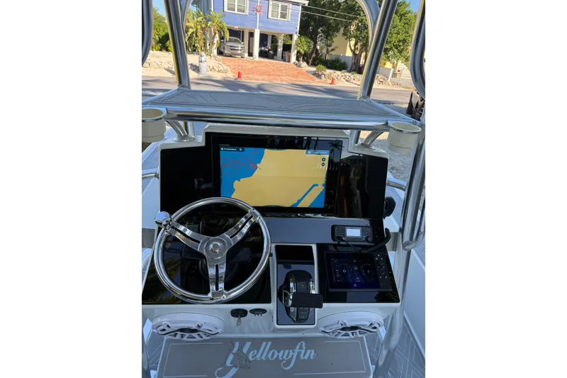 Slide: The Image of 2016 Yellowfin 24 Bay boat dashboard with navigation screen and steering wheel. - 19