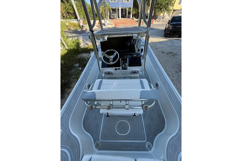 Slide: The Image of 2016 Yellowfin 24 Bay boat interior with steering console and seating. - 8