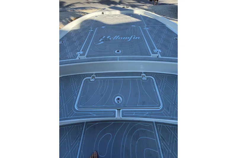 Slide: The Image of 2016 Yellowfin 24 Bay boat deck with logo and storage compartments. - 9