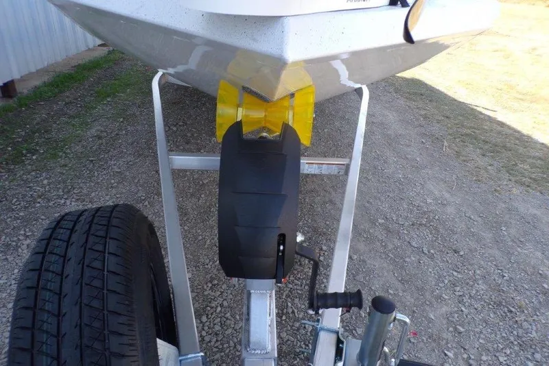 Slide: The Image of 2026 Xpress H20B Bay boat on trailer, featuring yellow bow stop and black roller. - 15