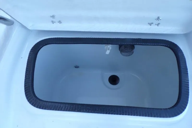 Slide: The Image of Livewell compartment in 2026 Xpress H20B Bay boat, featuring a drain and aerator. - 16