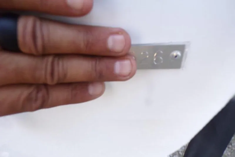 Slide: The Image of Hand touching metal plate on 2026 Xpress H20B Bay boat. - 17