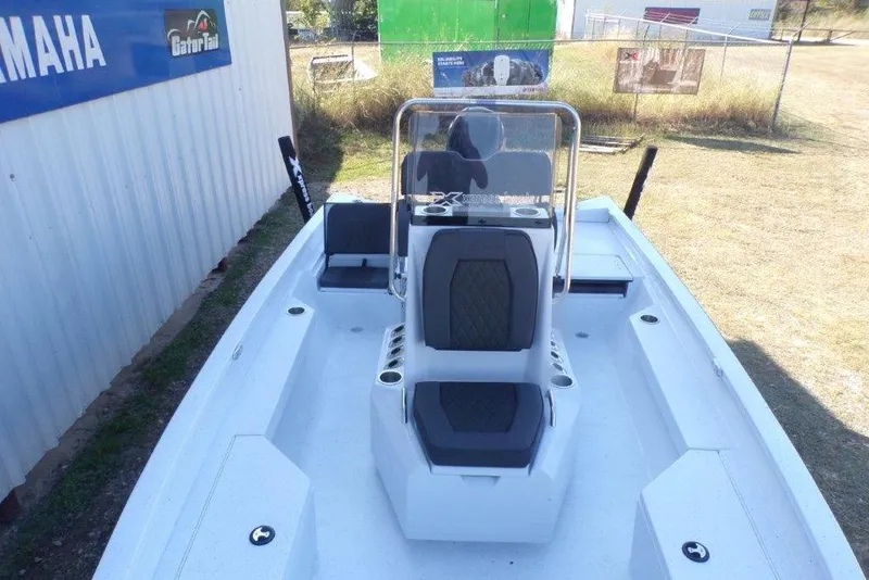 Slide: The Image of 2026 Xpress H20B Bay boat with seating and console, displayed outdoors. - 2