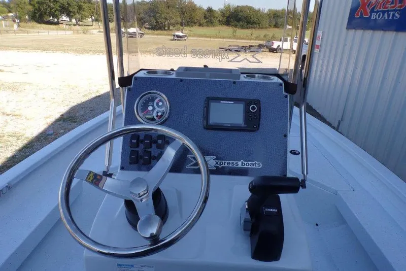 Slide: The Image of 2026 Xpress H20B Bay boat dashboard with steering wheel and control panel. - 21