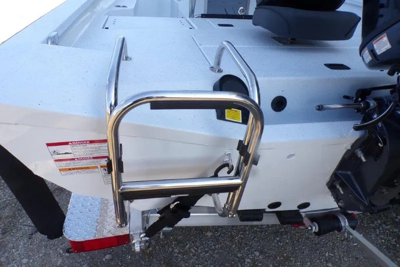 Slide: The Image of 2026 Xpress H20B Bay boat with stainless steel ladder and motor detail. - 24
