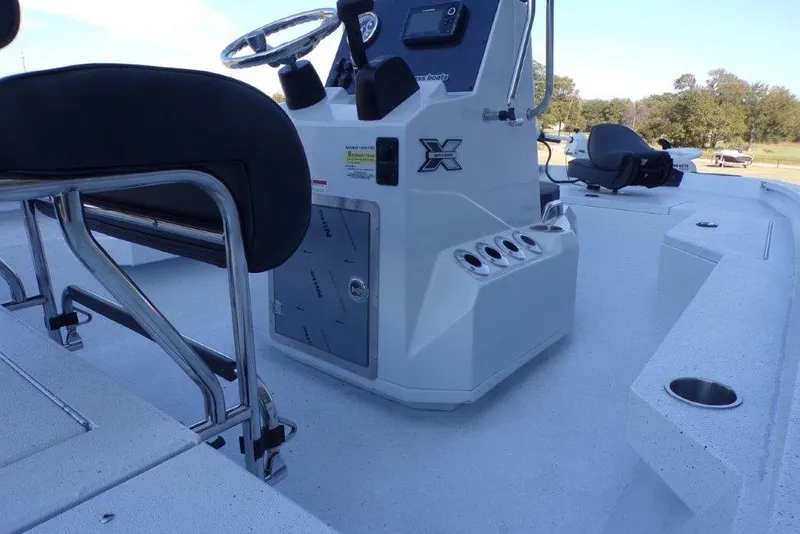 Slide: The Image of 2026 Xpress H20B Bay boat interior with steering console and seating. - 25