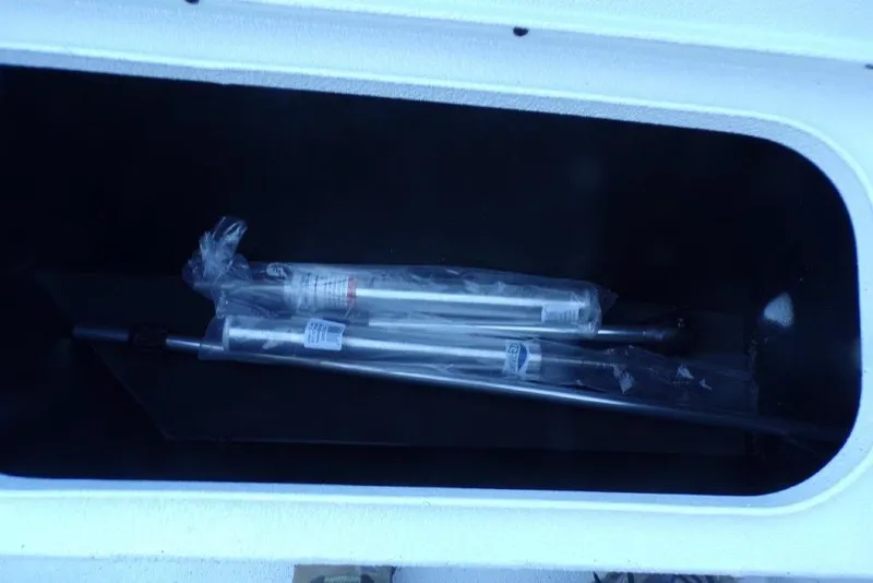 Slide: The Image of Storage compartment of 2026 Xpress H20B Bay boat with packaged equipment inside. - 7