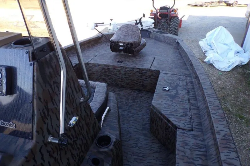 Slide: The Image of 2026 Xpress H20B Bay boat interior with camo design and seating. - 10