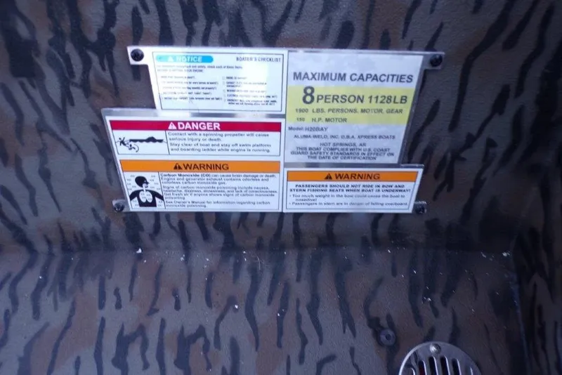 Slide: The Image of Safety and capacity labels on 2026 Xpress H20B Bay boat interior. - 11