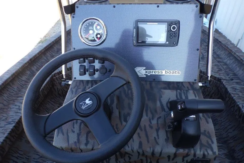 Slide: The Image of 2026 Xpress H20B Bay boat dashboard with steering wheel and control panel. - 12