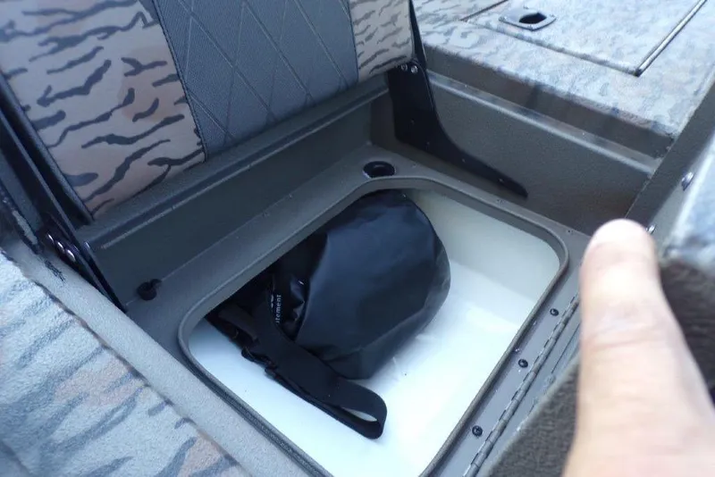 Slide: The Image of Storage compartment in 2026 Xpress H20B Bay boat with camo seating. - 13