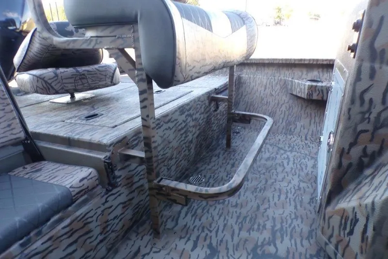 Slide: The Image of 2026 Xpress H20B Bay boat interior with camouflage seating and flooring design. - 14