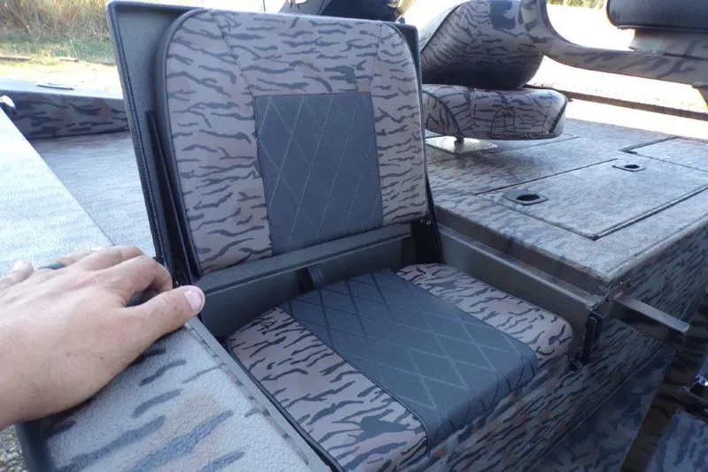 Slide: The Image of 2026 Xpress H20B Bay boat with camo-patterned seating and storage compartments. - 15