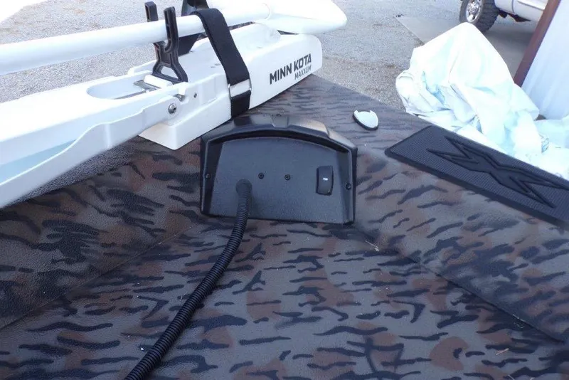 Slide: The Image of 2026 Xpress H20B Bay boat with Minn Kota trolling motor on camo deck. - 7