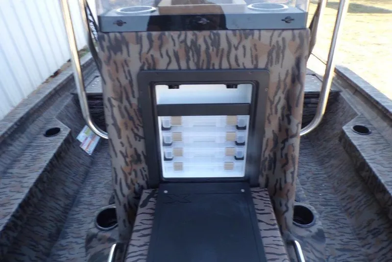Slide: The Image of 2026 Xpress H20B Bay boat interior with camouflage design and storage compartment. - 9