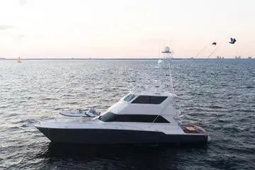 The Image of 1999 Viking 72 Enclosed Bridge yacht on open water at sunset. - 0