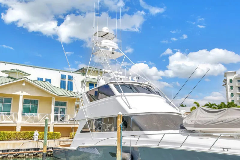 Slide: The Image of 1999 Viking 72 Enclosed Bridge yacht docked under blue sky. - 10