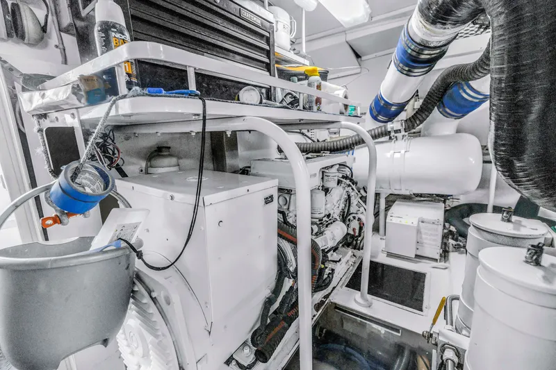 Slide: The Image of Engine room of 1999 Viking 72 Enclosed Bridge yacht, showcasing machinery and equipment. - 100
