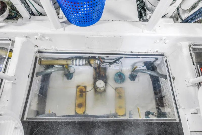 Slide: The Image of Engine room of 1999 Viking 72 Enclosed Bridge yacht, showcasing mechanical components. - 105