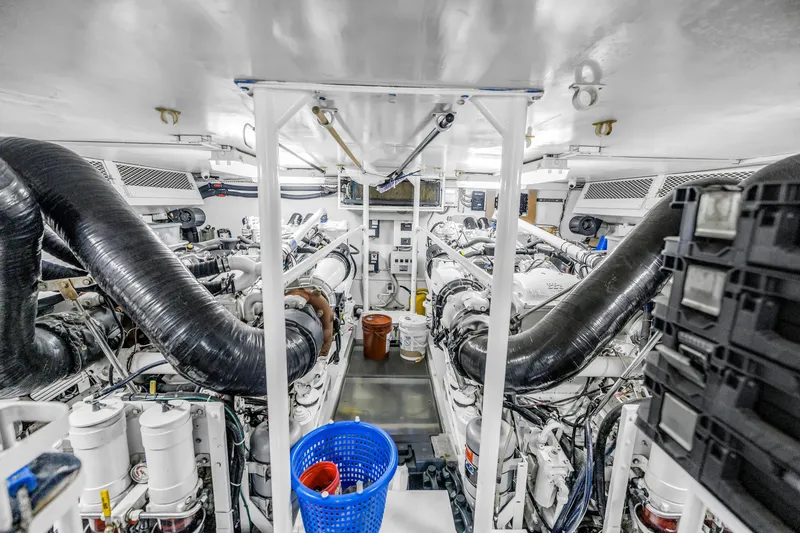 Slide: The Image of Engine room of a 1999 Viking 72 Enclosed Bridge yacht, showcasing machinery and equipment. - 106
