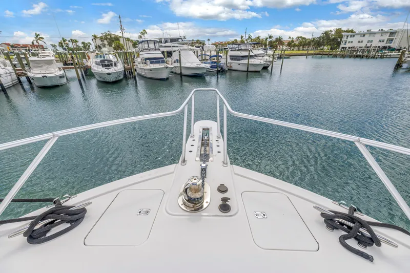 Slide: The Image of Bow view of 1999 Viking 72 Enclosed Bridge yacht in marina. - 18