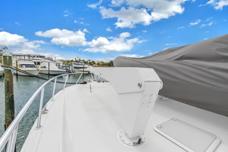 Slide: The Image of 1999 Viking 72 Enclosed Bridge yacht docked at marina under blue sky. - 19