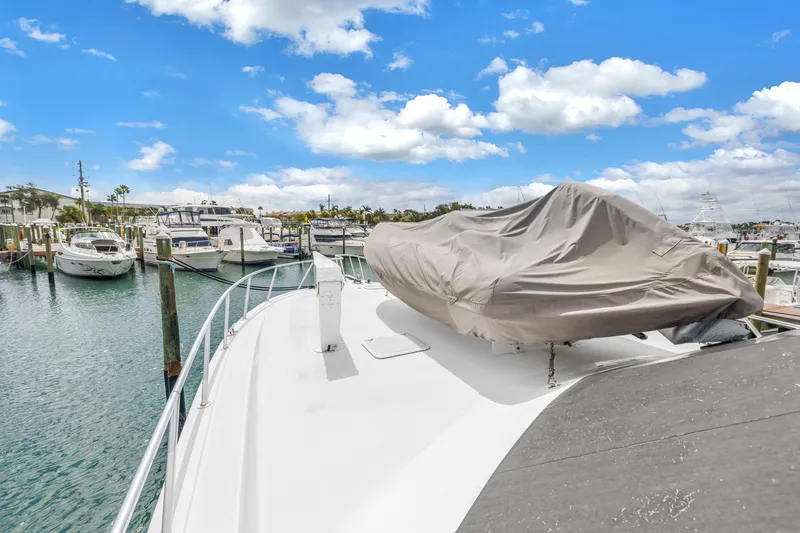 Slide: The Image of 1999 Viking 72 Enclosed Bridge yacht docked at marina under blue sky. - 20