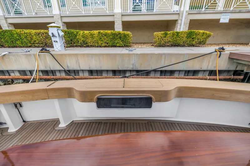 Slide: The Image of 1999 Viking 72 Enclosed Bridge yacht docked, featuring teak deck and seating area. - 22