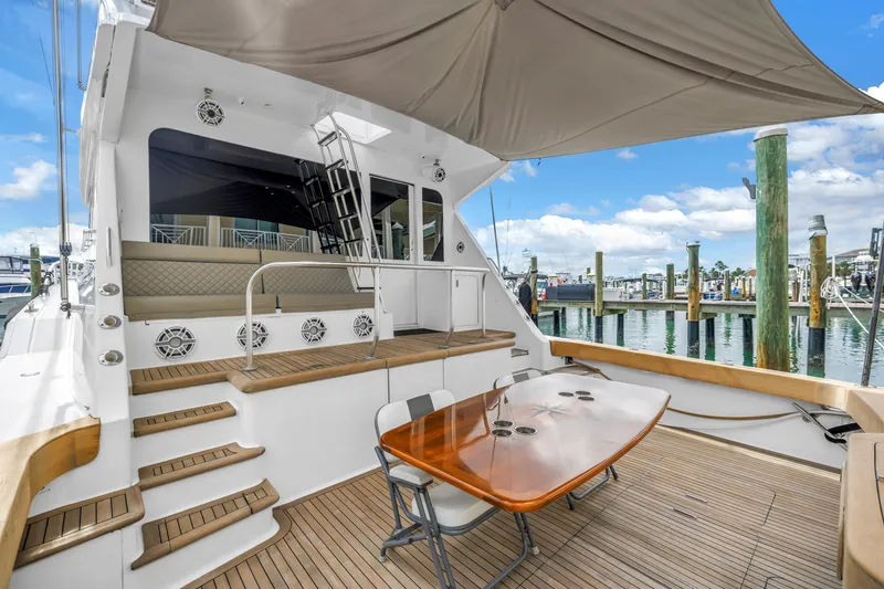 Slide: The Image of 1999 Viking 72 Enclosed Bridge yacht with teak deck and outdoor seating at marina. - 25