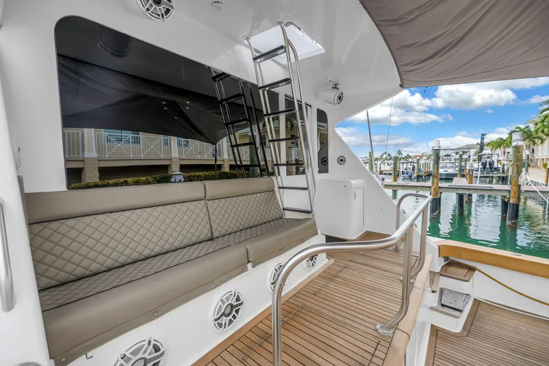 Slide: The Image of 1999 Viking 72 Enclosed Bridge yacht with elegant seating and marina view. - 27