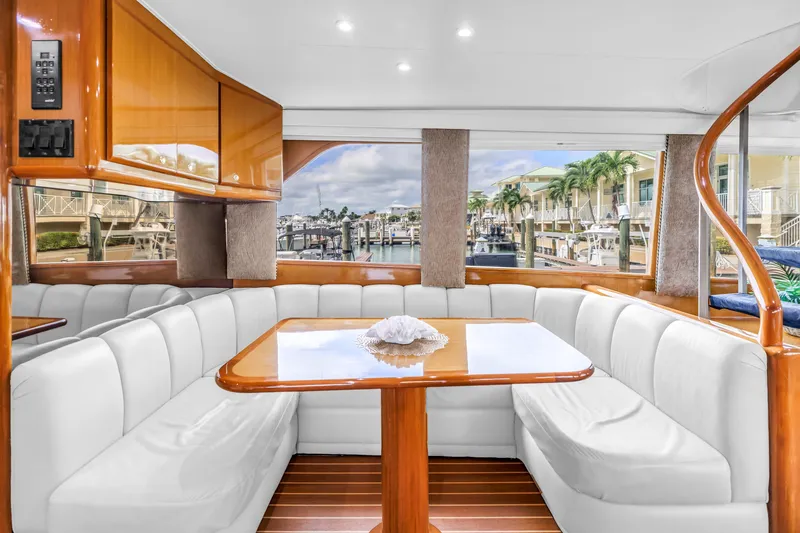 Slide: The Image of Luxurious interior of 1999 Viking 72 Enclosed Bridge yacht with elegant seating and marina view. - 35