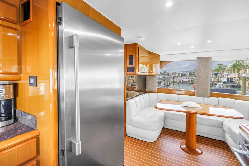 Slide: The Image of Luxurious interior of 1999 Viking 72 Enclosed Bridge yacht with modern kitchen and dining area. - 37
