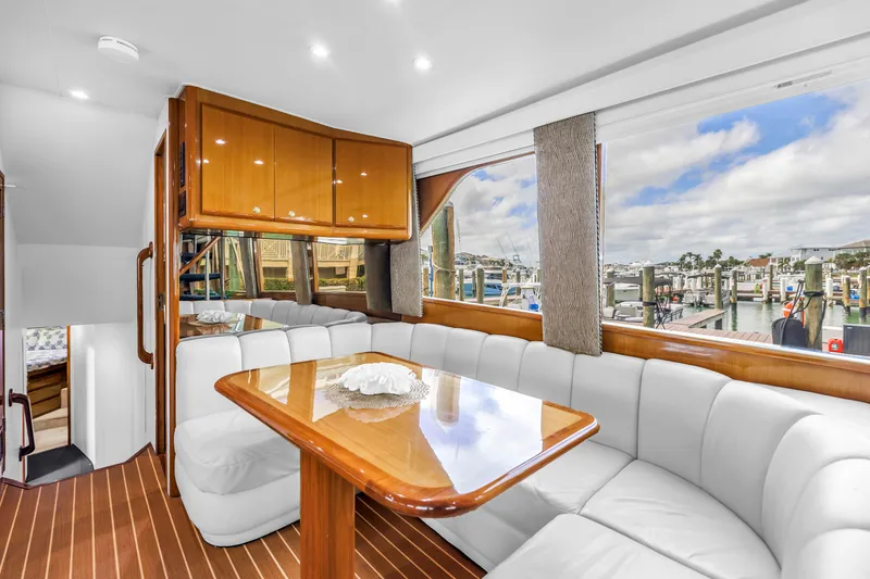 Slide: The Image of Luxurious interior of 1999 Viking 72 Enclosed Bridge yacht with elegant seating and marina view. - 38