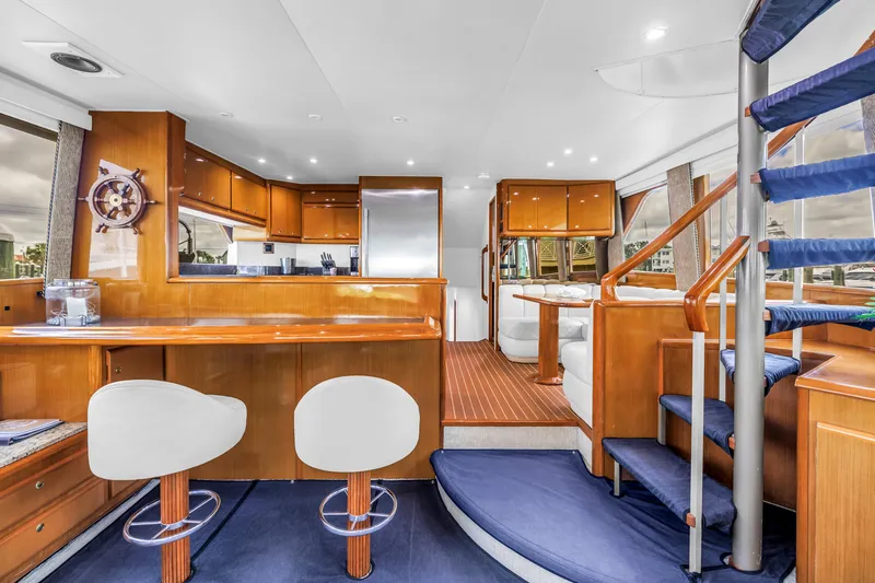 Slide: The Image of Luxurious interior of 1999 Viking 72 Enclosed Bridge yacht with elegant wood finishes. - 39