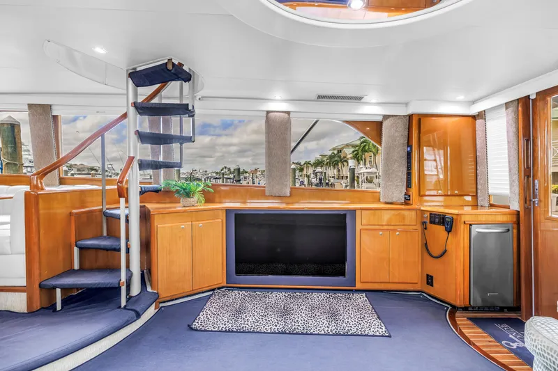 Slide: The Image of Luxurious interior of 1999 Viking 72 Enclosed Bridge yacht with spiral staircase and modern amenities. - 40