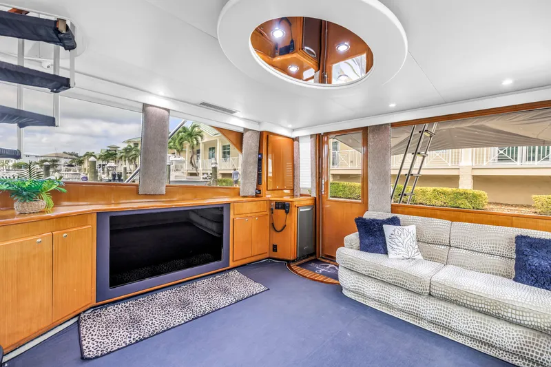 Slide: The Image of Luxurious interior of 1999 Viking 72 Enclosed Bridge yacht with plush seating and modern decor. - 45