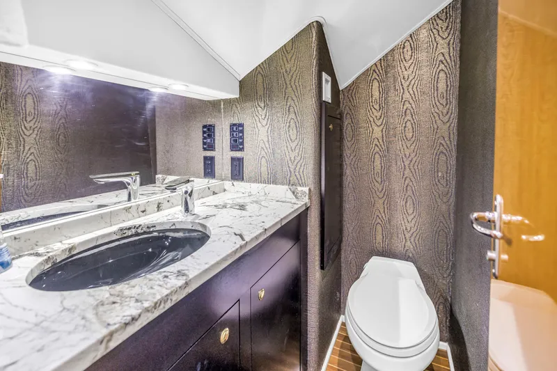 Slide: The Image of Luxurious bathroom in 1999 Viking 72 Enclosed Bridge yacht with marble countertop and modern fixtures. - 50