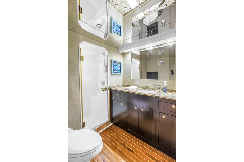 Slide: The Image of Luxurious bathroom in 1999 Viking 72 Enclosed Bridge yacht with modern fixtures and wood flooring. - 53