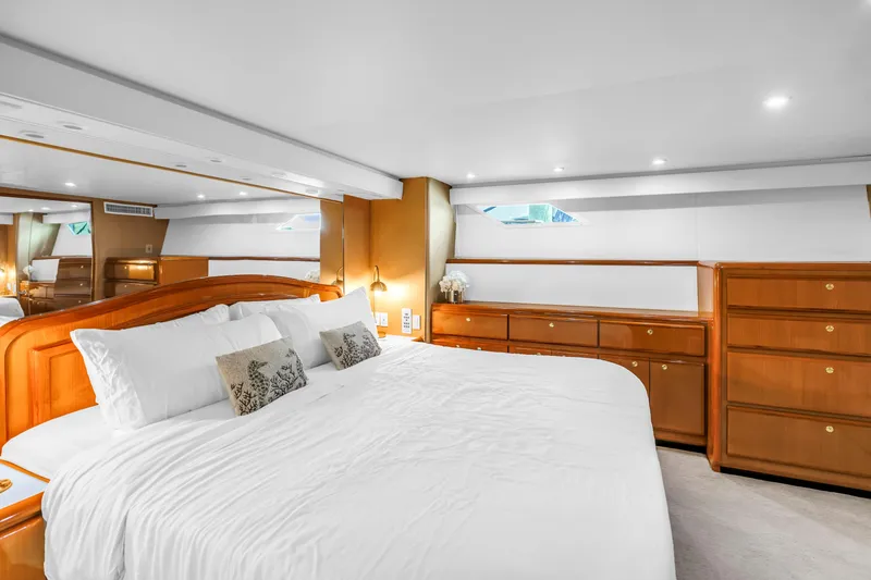 Slide: The Image of Luxurious bedroom interior of 1999 Viking 72 Enclosed Bridge yacht with elegant wood furnishings. - 55
