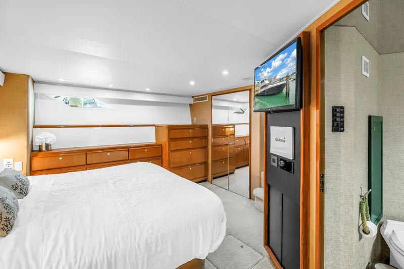 Slide: The Image of Luxurious bedroom interior of 1999 Viking 72 Enclosed Bridge yacht with modern amenities. - 56