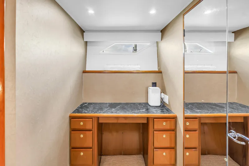 Slide: The Image of Luxurious interior of 1999 Viking 72 Enclosed Bridge yacht with elegant wood cabinetry. - 57