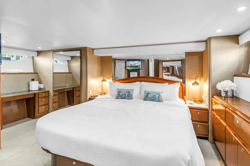 Slide: The Image of Luxurious bedroom interior of 1999 Viking 72 Enclosed Bridge yacht with elegant furnishings. - 60