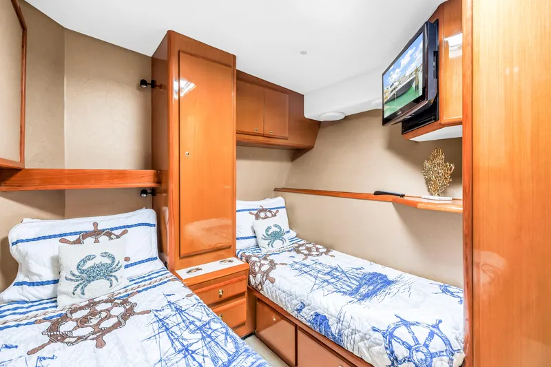 Slide: The Image of Cozy twin cabin in 1999 Viking 72 Enclosed Bridge yacht with nautical decor. - 61