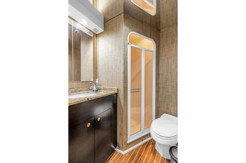 Slide: The Image of Bathroom interior of 1999 Viking 72 Enclosed Bridge yacht, featuring modern fixtures and wood flooring. - 66